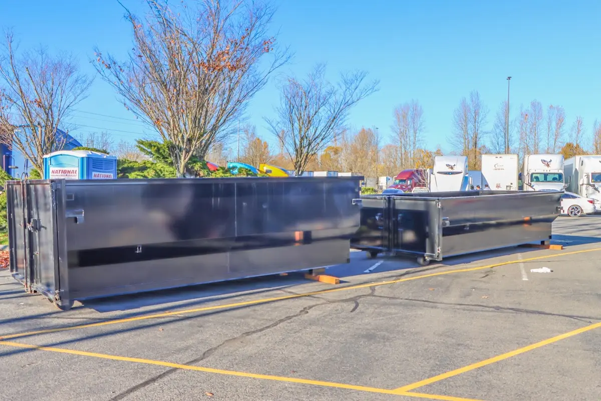 Professional dumpster rental service with roll-off container on residential driveway in San Carlos Park